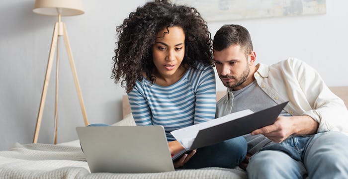 a man and a woman looking at a laptop