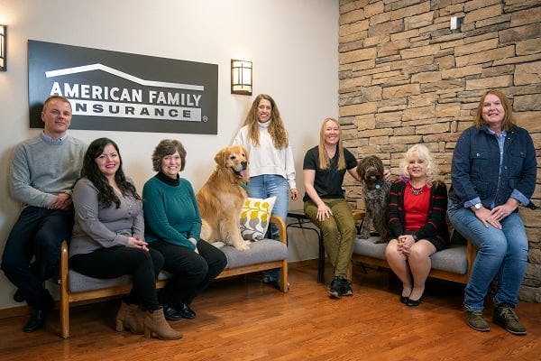 a group of people sitting on a couch with a dog